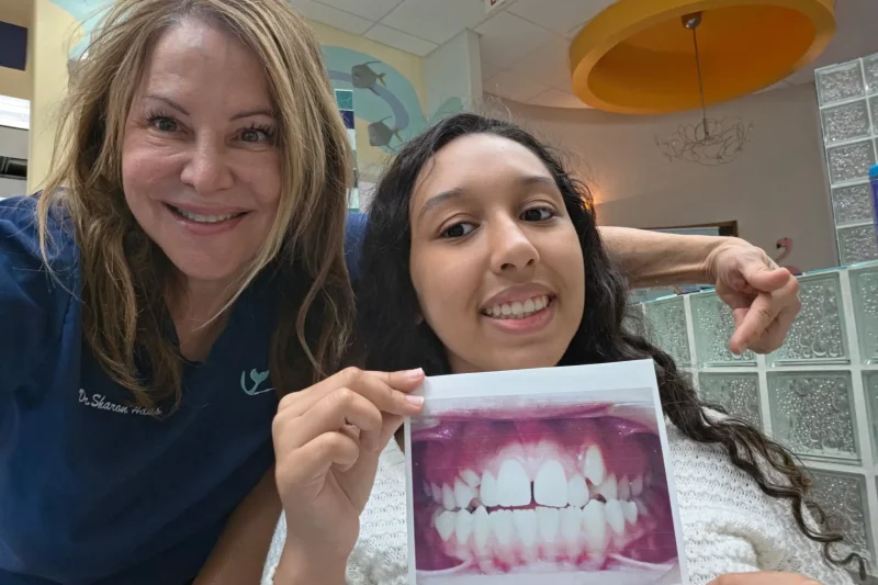 a smile with a small diastema gap between the two upper front teeth resolved by an orthodontist
